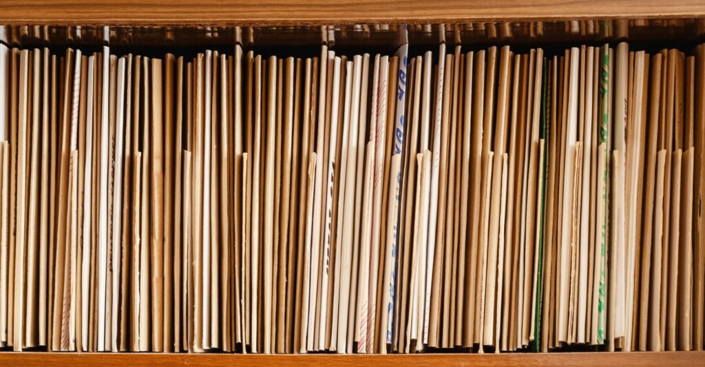 a shot of a shelf filled with cream manilla folders and files.