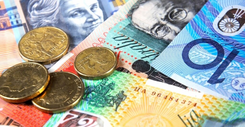 a close up photo of australian money - a ten dollar note, a twenty dollar note, a one hundred dollar note, a fifty dollar note, a two dollar coin and three one dollar coins.