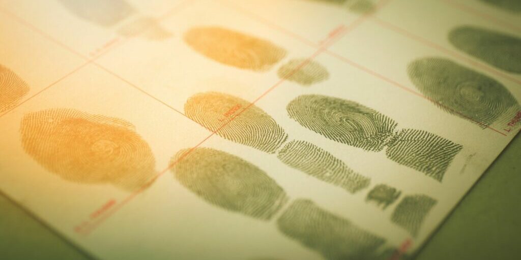 a piece of paper with various finger prints on it - commonly seen when police need to collect fingerprints from suspects or criminals