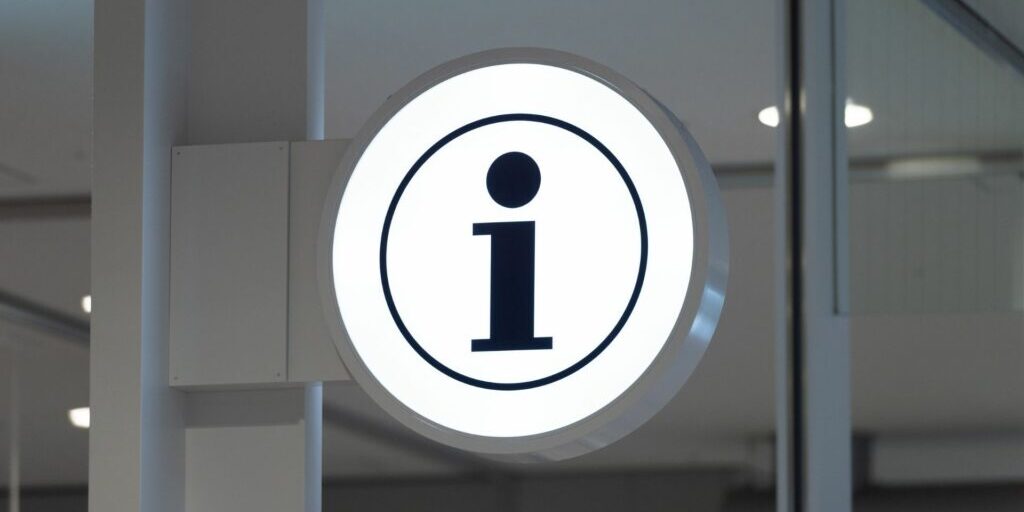 An white circular sign with the letter 'i' in the middle - an information sign