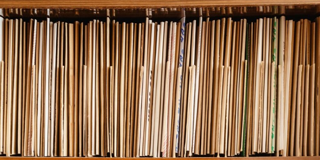 a shot of a shelf filled with cream manilla folders and files.