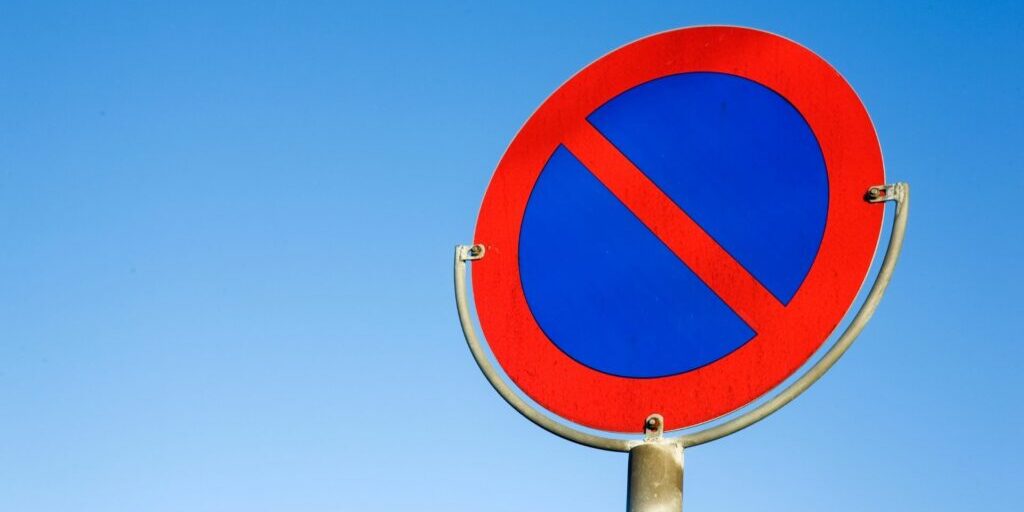 A red 'no' sign against a blue sky background