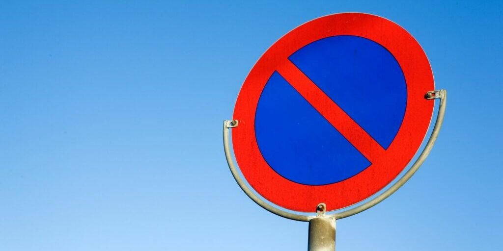 A red 'no' sign against a blue sky background