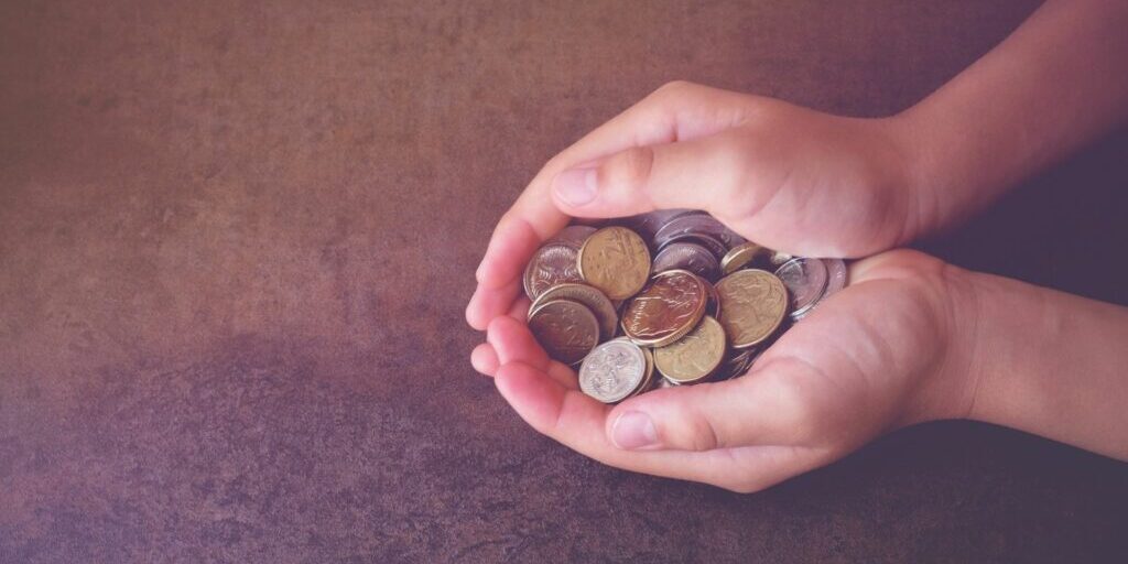 a photo of two hands acting as a bowl to carry a bunch of Australian coins